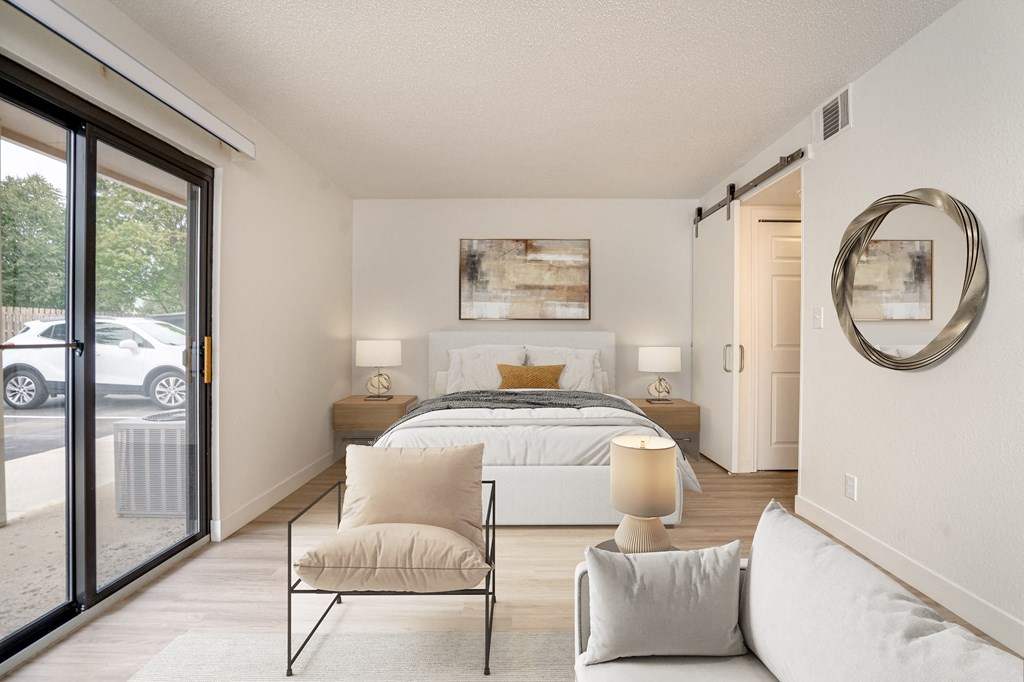 a bedroom with a large bed and sliding glass doors